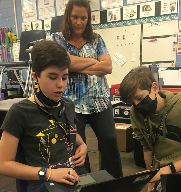 A cartoon alpaca wearing sunglasses with a rainbow above its head.